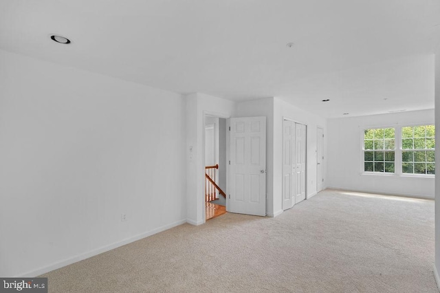 empty room with light colored carpet