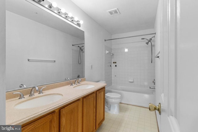 full bathroom with toilet, tiled shower / bath combo, and vanity