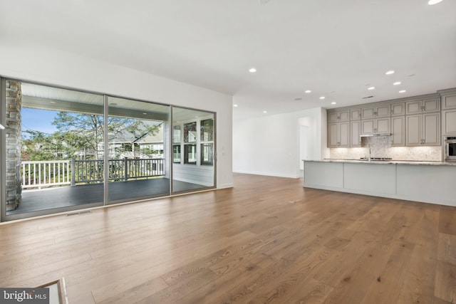 unfurnished living room featuring hardwood / wood-style floors