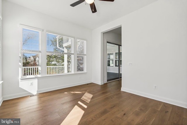 unfurnished room featuring dark hardwood / wood-style floors and ceiling fan