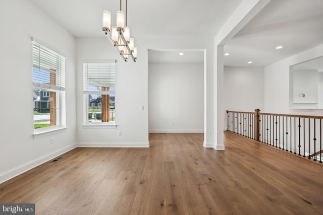 interior space featuring wood-type flooring and a notable chandelier