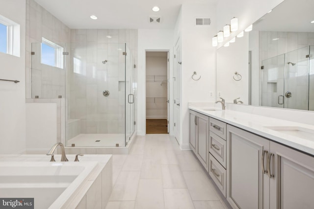 bathroom with vanity, tile patterned flooring, and separate shower and tub