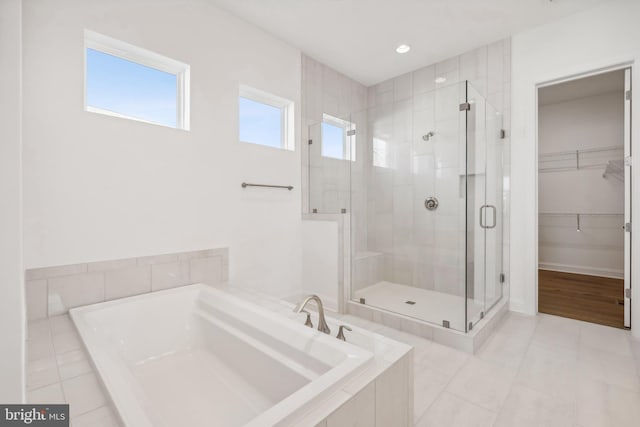 bathroom with tile patterned floors and separate shower and tub