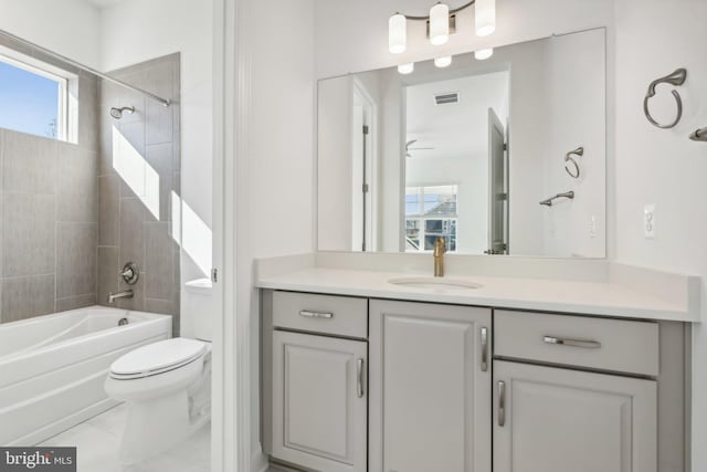 full bathroom with tile patterned flooring, vanity, toilet, and tiled shower / bath combo