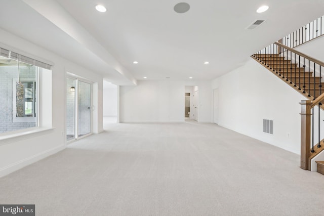 unfurnished living room with light colored carpet