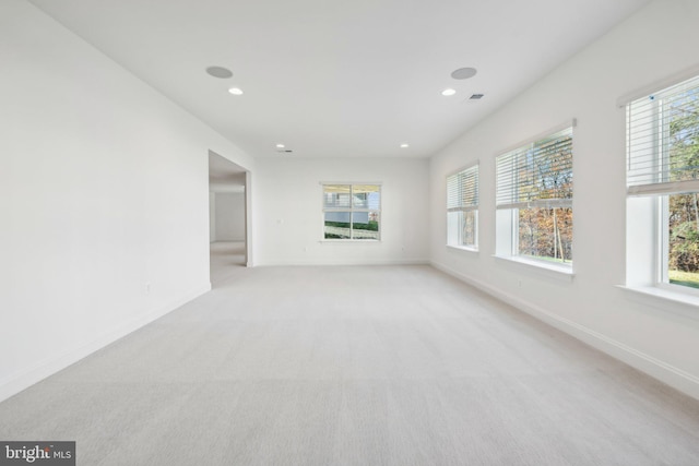 carpeted spare room featuring a wealth of natural light