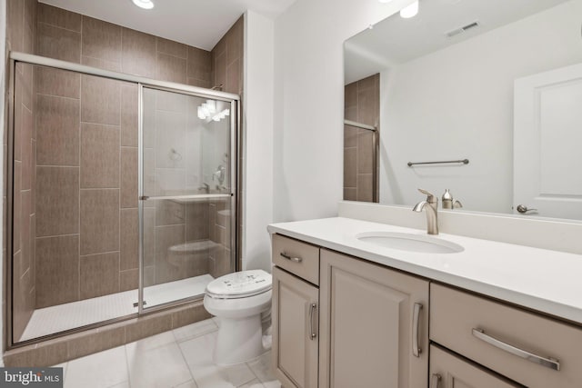 bathroom featuring walk in shower, toilet, vanity, and tile patterned floors