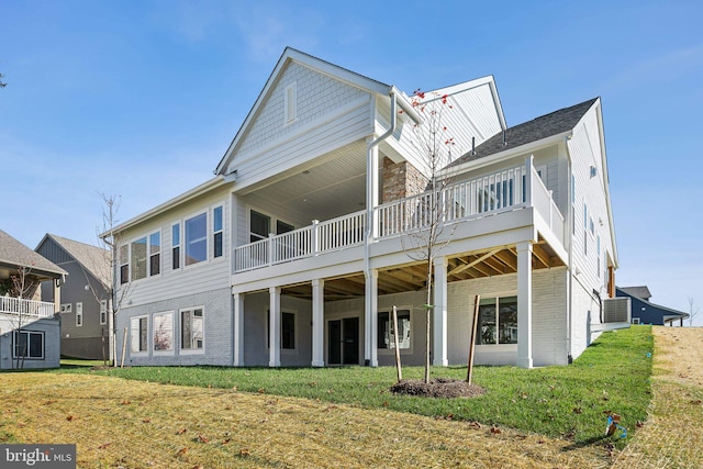 back of property featuring a yard and a wooden deck