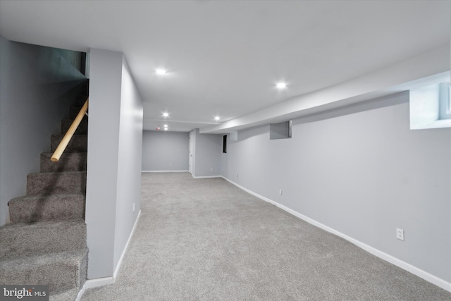 basement featuring light colored carpet