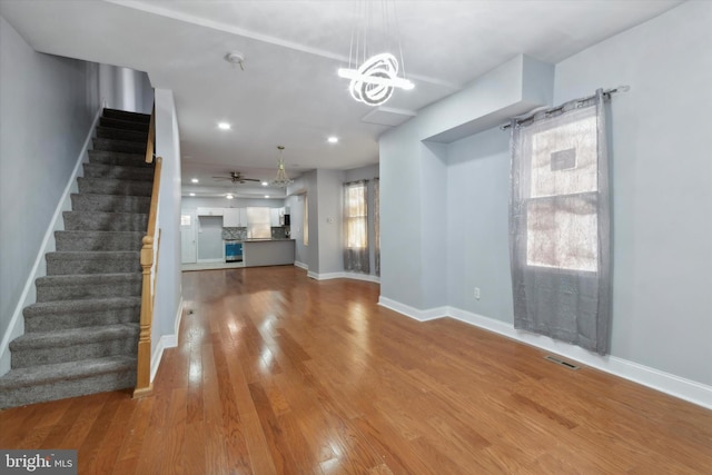 unfurnished living room featuring light hardwood / wood-style floors and ceiling fan