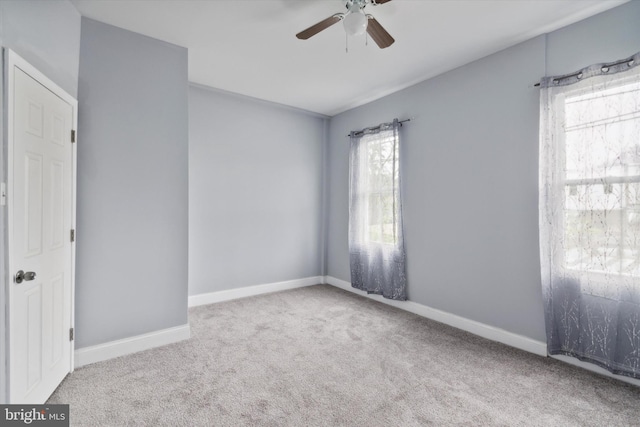 spare room with light carpet and ceiling fan