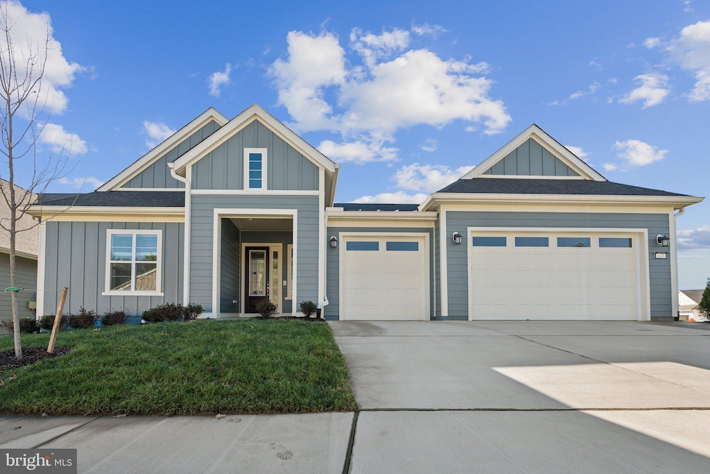 view of front of home with a garage and a front yard