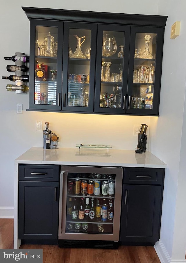 bar featuring wine cooler and dark hardwood / wood-style flooring