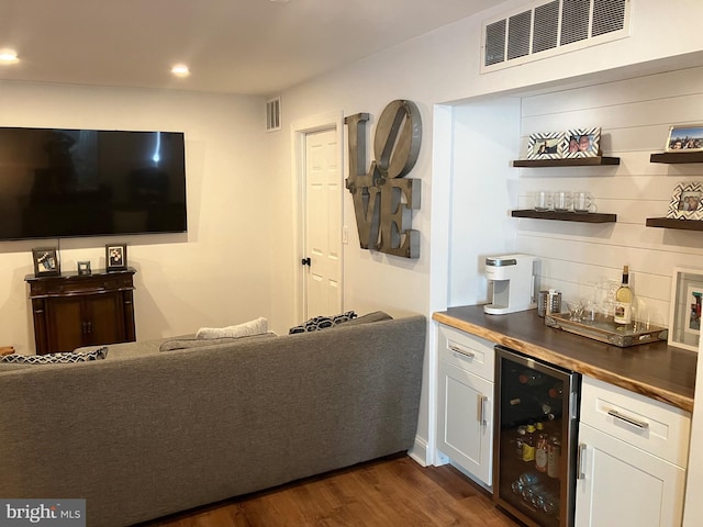 bar with white cabinets, dark hardwood / wood-style flooring, wine cooler, and butcher block counters