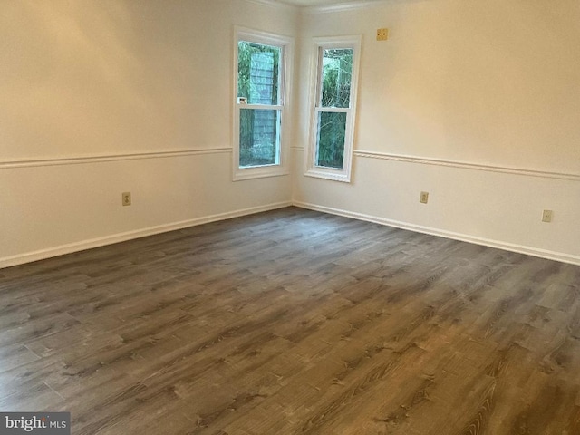 spare room with dark hardwood / wood-style flooring