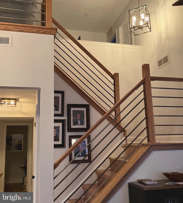 staircase with a chandelier