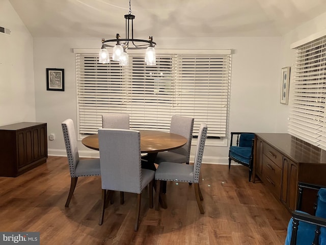 dining room featuring dark hardwood / wood-style floors and a notable chandelier