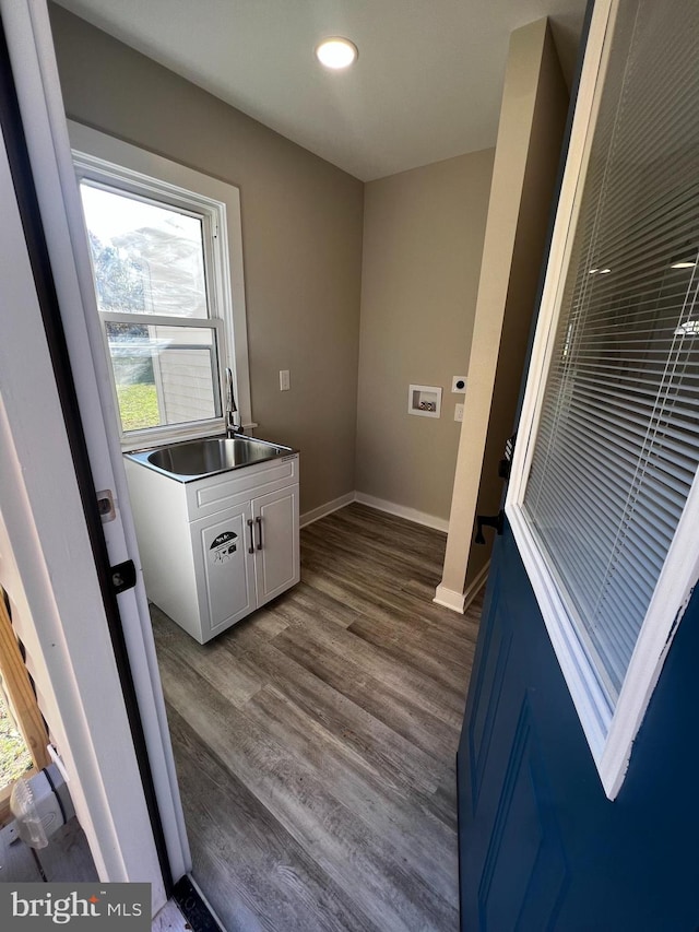 washroom with hardwood / wood-style flooring, washer hookup, and sink