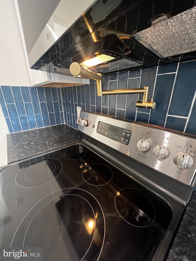 interior details with backsplash and stainless steel range with electric cooktop