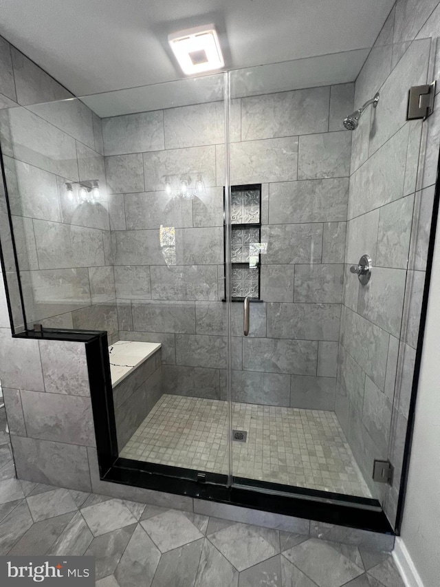 bathroom featuring a shower with shower door