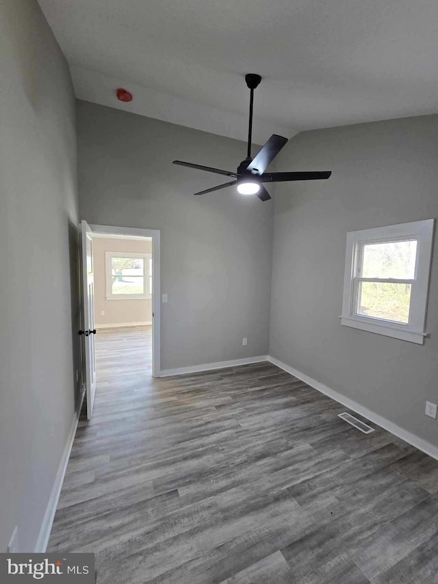 unfurnished room featuring wood-type flooring, ceiling fan, and lofted ceiling