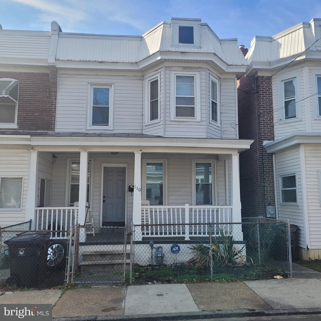 townhome / multi-family property featuring covered porch