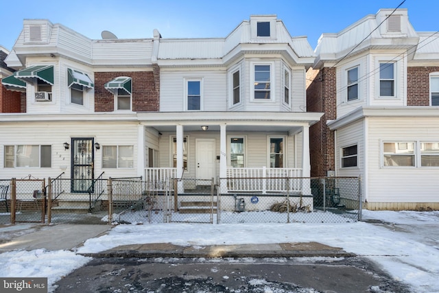 townhome / multi-family property with a porch