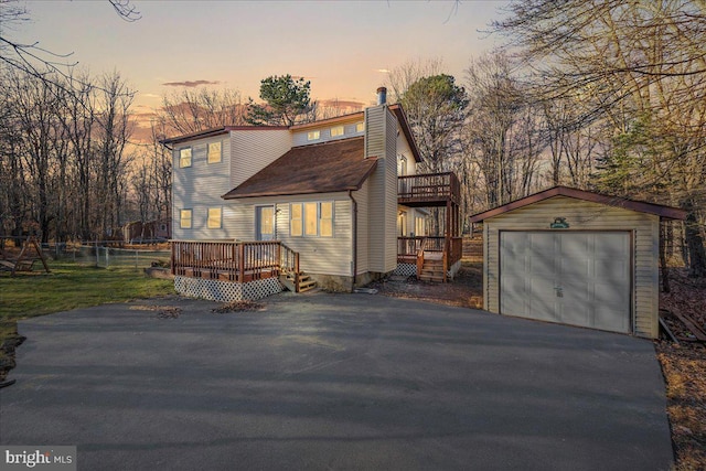 view of front of property with an outbuilding, a garage, and a deck