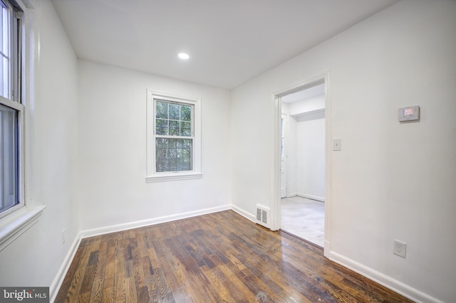 empty room with dark hardwood / wood-style flooring