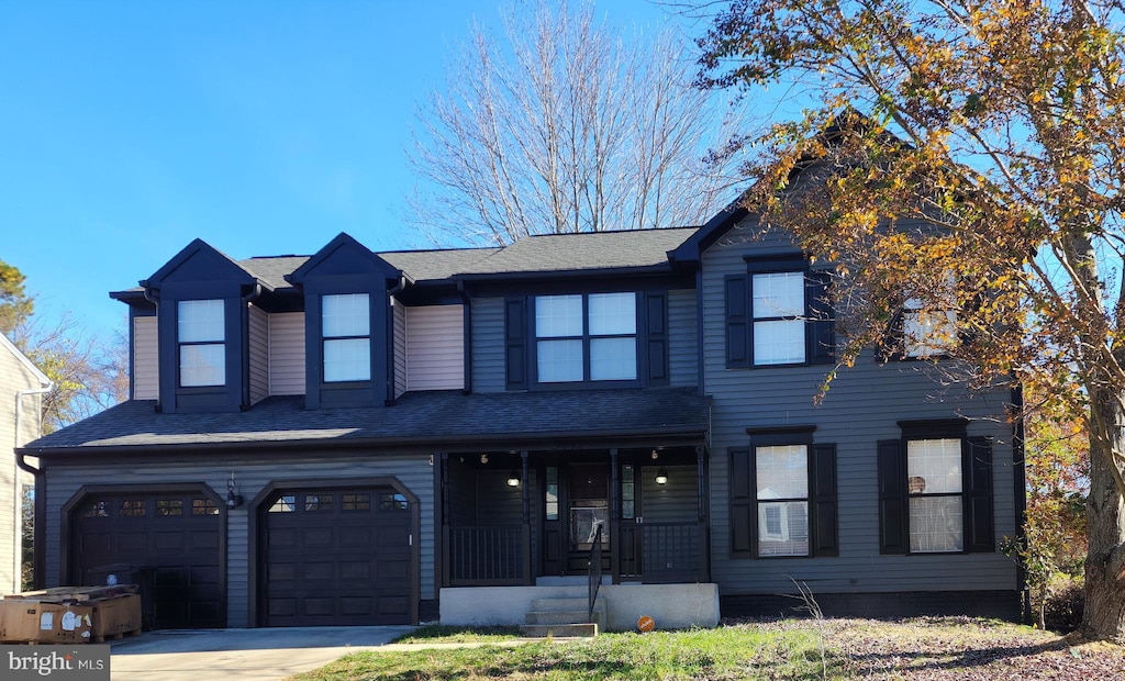 view of front of house featuring a porch and a garage