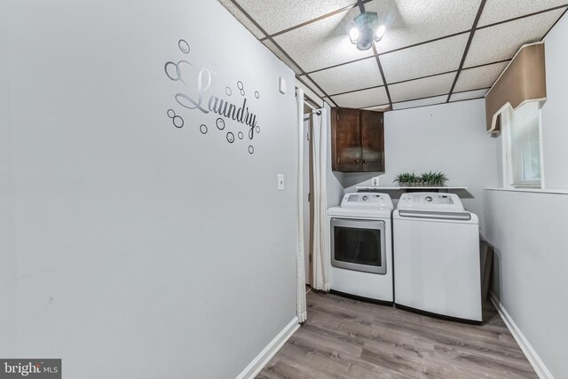 laundry area with light wood-type flooring and washing machine and dryer