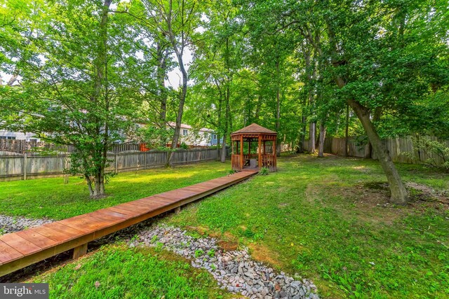 view of yard with a deck and a gazebo