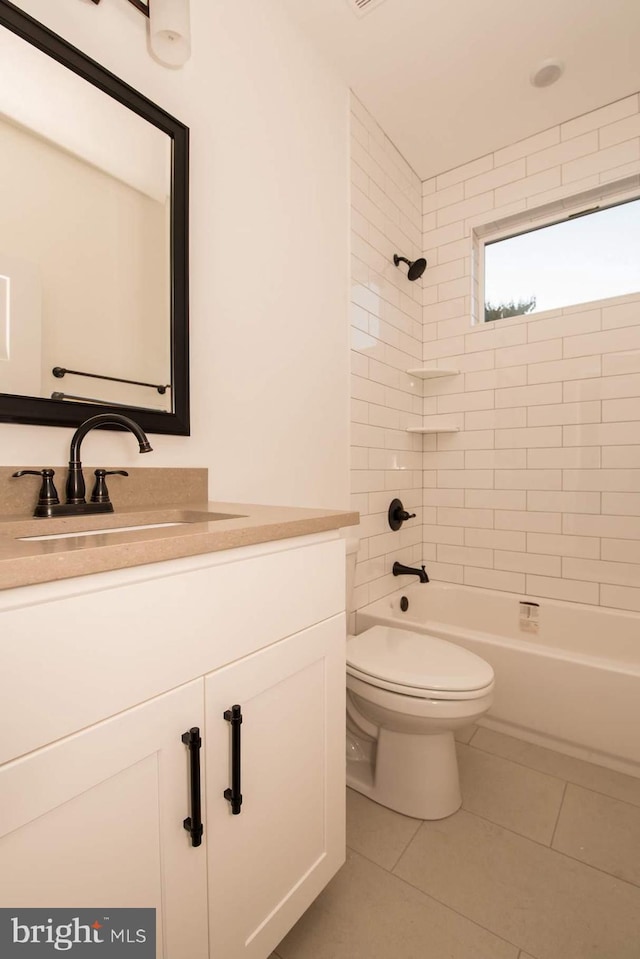 full bathroom with vanity, tile patterned floors, toilet, and tiled shower / bath combo