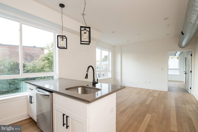 kitchen featuring sink, light hardwood / wood-style flooring, white cabinets, pendant lighting, and dishwasher