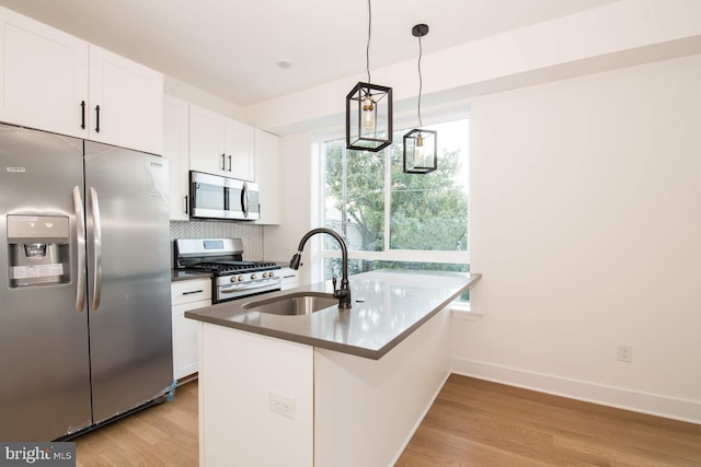 kitchen featuring light wood-type flooring, white cabinets, sink, and stainless steel appliances