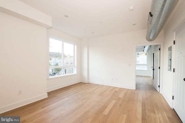 spare room with light hardwood / wood-style flooring