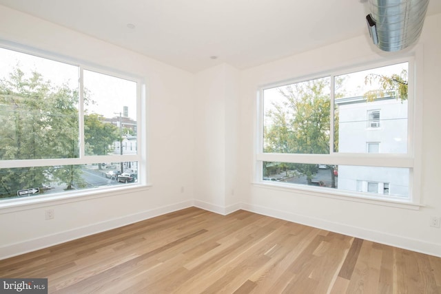 empty room featuring hardwood / wood-style floors and plenty of natural light