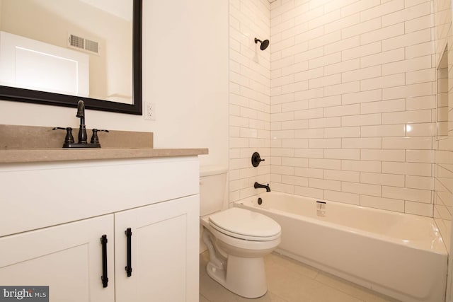 full bathroom featuring toilet, vanity, tiled shower / bath, and tile patterned floors