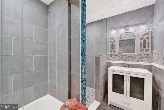 bathroom featuring vanity, tile walls, and independent shower and bath