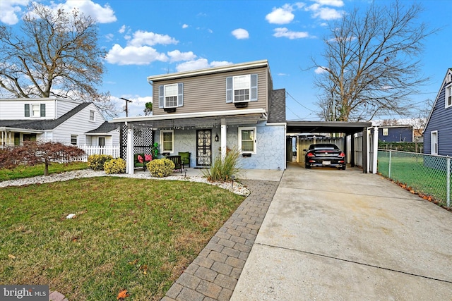 view of front property featuring a front lawn, a porch, and a carport