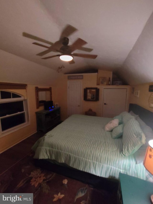 bedroom featuring ceiling fan and lofted ceiling