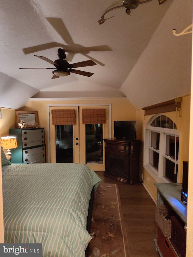 bedroom with dark hardwood / wood-style floors, ceiling fan, and lofted ceiling