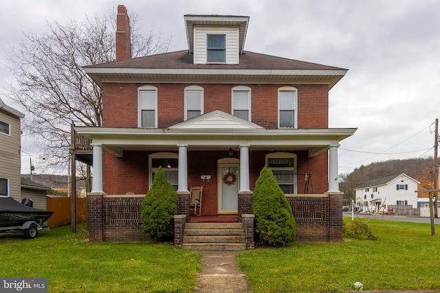 view of front of home featuring a front yard and a porch