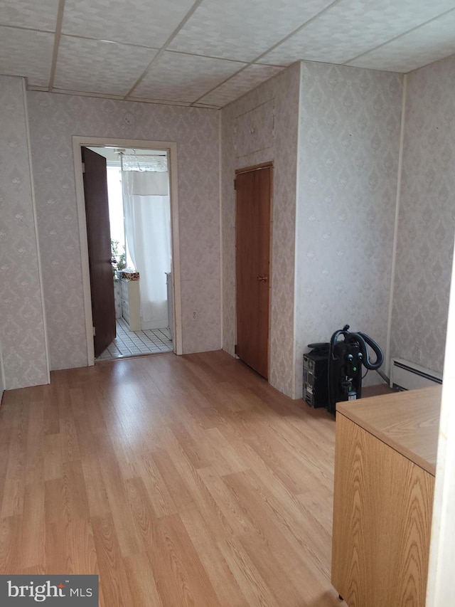 interior space featuring light wood-type flooring and baseboard heating