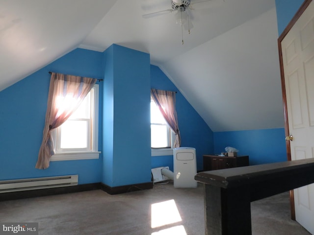 additional living space featuring carpet floors, a baseboard radiator, vaulted ceiling, and ceiling fan