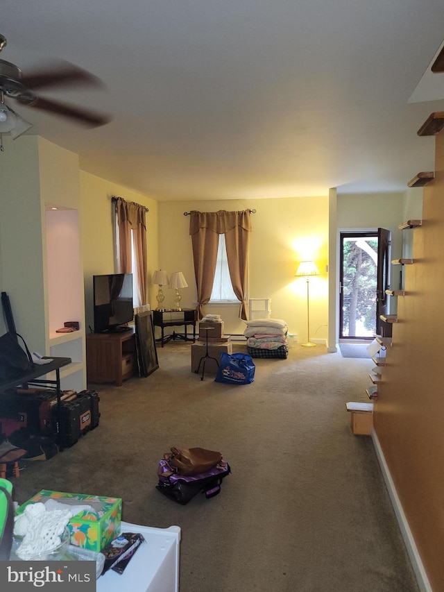 living room with ceiling fan and carpet