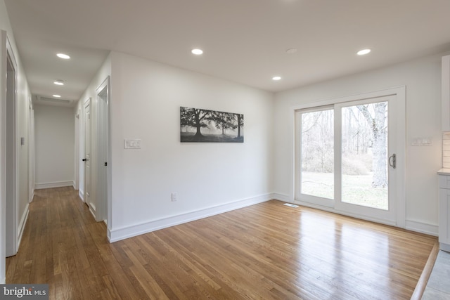 unfurnished room featuring hardwood / wood-style flooring and a healthy amount of sunlight