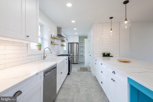 kitchen with white cabinetry, pendant lighting, wall chimney exhaust hood, and stainless steel appliances