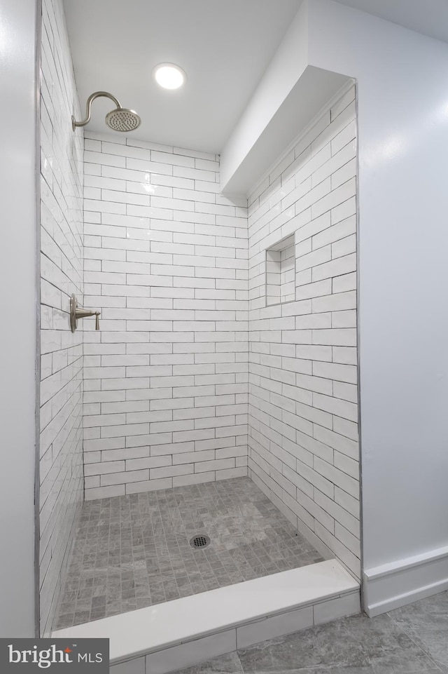 bathroom with tiled shower