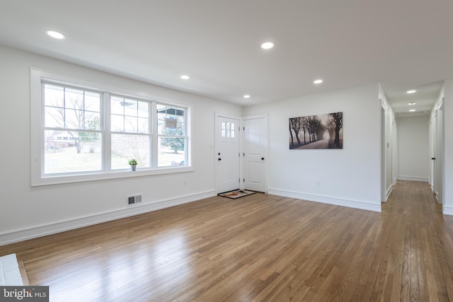 entrance foyer with hardwood / wood-style flooring and a wealth of natural light